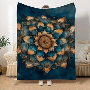 Elegant teal and gold mandala flannel blanket being held in a bright modern living room