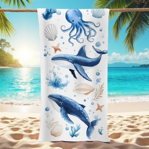 Microfiber beach towel with watercolor sea creatures hanging by the ocean shore