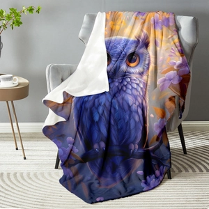 Purple owl floral flannel blanket draped on sofa with soft white fleece backing