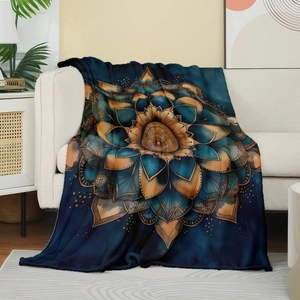 Cosy blue mandala flannel blanket draped over a sofa in a warm home interior setting