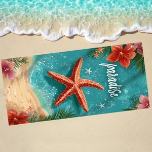 Microfiber beach towel with red starfish and tropical flowers on a sandy beach