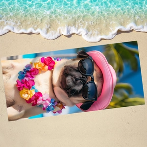Pink pug microfiber beach towel with floral garland lying on the sunny sand near waves