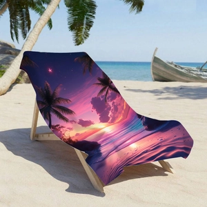 Microfiber beach towel with sunset palm tree print displayed on a wooden lounge chair