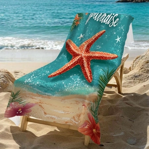 Microfiber beach towel with red starfish print and Paradise text on a wooden chair