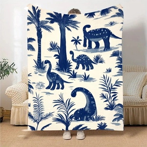 Detail of cartoon dinosaur print flannel blanket with retro palm tree pattern art