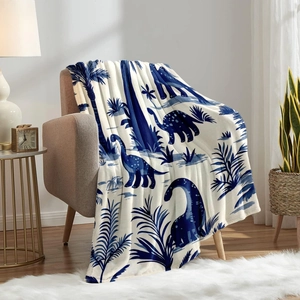 Soft flannel dinosaur print blanket draped on a chair in a modern cozy room setup