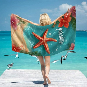 Microfiber beach towel with red starfish and tropical paradise print on seaside pier