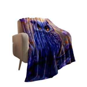 Purple owl flannel blanket with vibrant digital print on a cozy light brown sofa