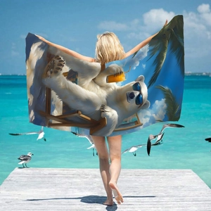 Microfiber beach towel with cartoon polar bear print shown by a woman on a seaside pier