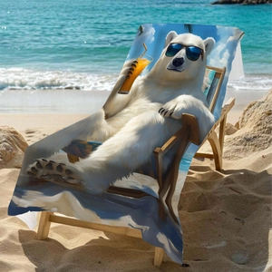 Microfiber beach towel with polar bear print on a lounge chair by the sea