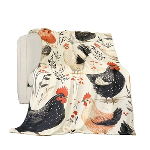 Flannel throw blanket with vintage rooster print draped over a white sofa armrest