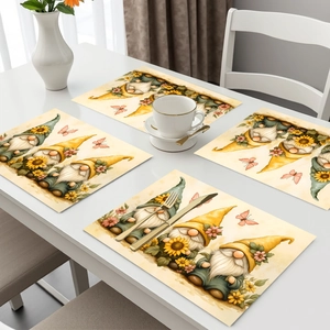 Detail view of 4-piece gnome floral placemats with butterflies on a white table