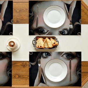 Macro shot of rectangular placemat with surrealist eye art illustration for modern dining décor