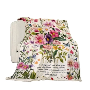 Floral flannel blanket with colorful flowers and vintage text on a white sofa