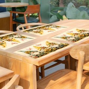 Set of 4 garden gnome placemats with sunflowers and butterflies on wooden table