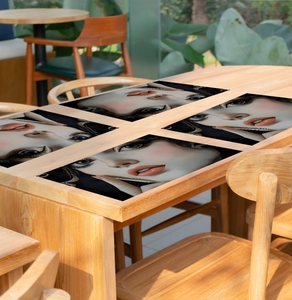 Detail of four heat-resistant table mats featuring modern artistic female face illustrations