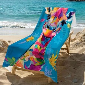 Colorful giraffe print microfiber beach towel displayed on a beach chair by the sea