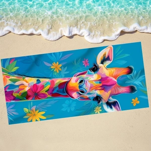 Colorful giraffe microfiber beach towel with tropical flowers on sunny coastal sand