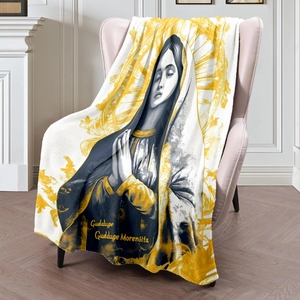 Guadalupe Virgin Mary printed flannel blanket draped over a pink sofa in a bright room