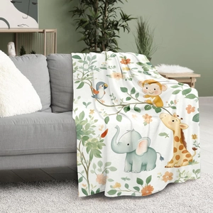 Jungle animal print flannel blanket with cartoon elephant and giraffe on a sofa