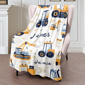 Custom cartoon construction truck flannel blanket with personalized names on a sofa