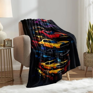 Detail of soft flannel blanket with colorful muscle car art draped on a sofa in a cozy room