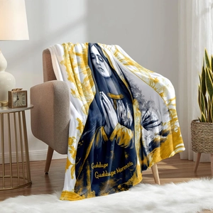 Navy blue and gold flannel Guadalupe blanket draped over an armchair in cozy home setting