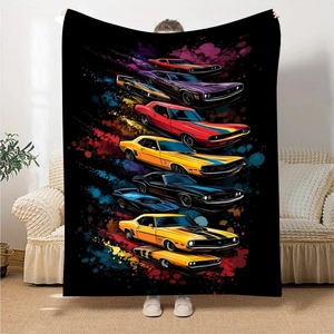 Detail view of colorful classic muscle car prints on a black flannel fleece blanket