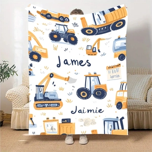 Custom flannel blanket showing bright cartoon construction trucks with name personalization