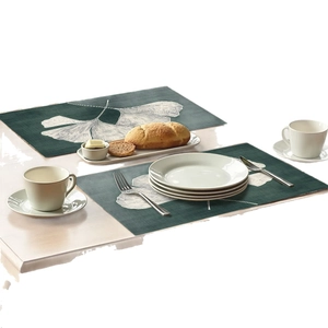 Set of 2 dark green placemats with white ginkgo leaf patterns for dining table decor