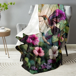 Hummingbird and flower print flannel blanket on sofa with plush white reverse side