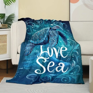 Detail of soft flannel blanket featuring a sea turtle and Love Sea ocean design