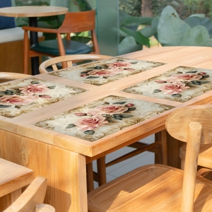 Set of 4 vintage pink rose placemats with gold floral border on wooden dining table