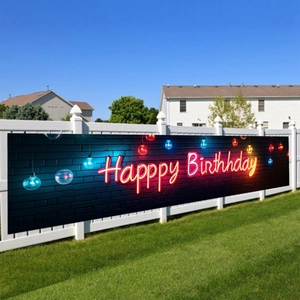 Neon style Happy Birthday banner displayed on a white fence for outdoor party decoration