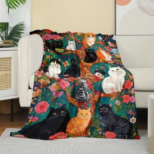 Artistic cat floral pattern flannel throw blanket draped over a beige fabric sofa