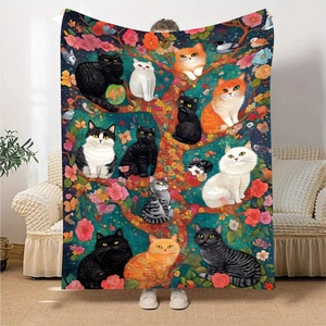 Vibrant flannel blanket featuring kittens in a flowery tree, displayed in a living room