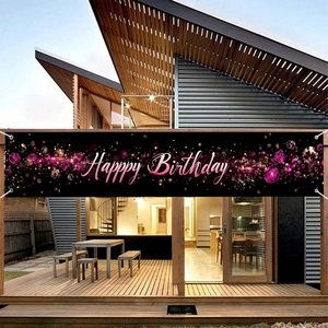 Bannière joyeux anniversaire rose et noire avec paillettes sur terrasse en bois