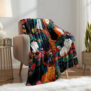 Digital print flannel blanket featuring colorful cat and flower illustrations on a cozy armchair