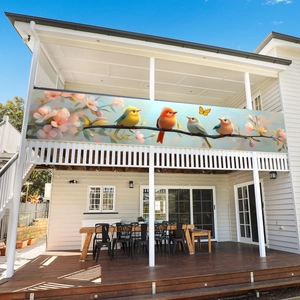 Outdoor garden banner featuring birds and floral design on a modern balcony fence