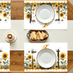Flat lay of sunflower gnome table mats with vibrant yellow bees on a wooden dining table