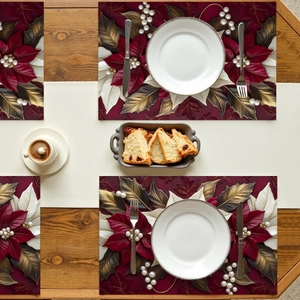 Floral poinsettia placemats with pearl accents on a wooden dining table setting