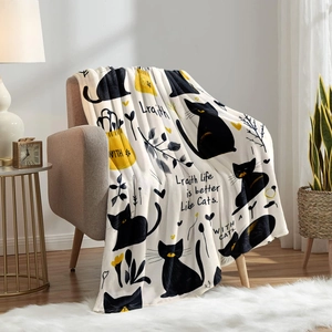 Soft white flannel blanket with black cat and yellow heart illustration on a cozy sofa