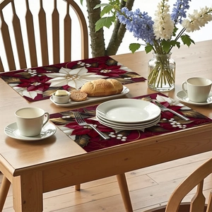 Detail of floral poinsettia placemats with pearl accents on a wooden dining table