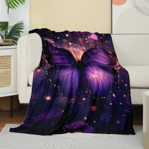 Detailed view of soft flannel throw blanket with artistic purple butterfly print on a sofa