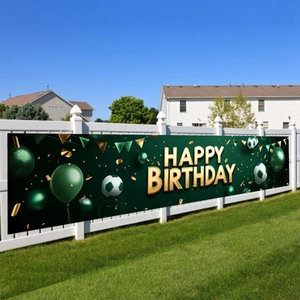 Green soccer birthday banner on a white fence for outdoor sports theme party