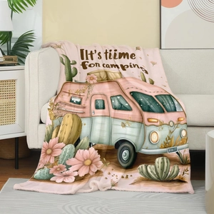 Detail of floral flannel blanket on sofa with camping van print and soft texture