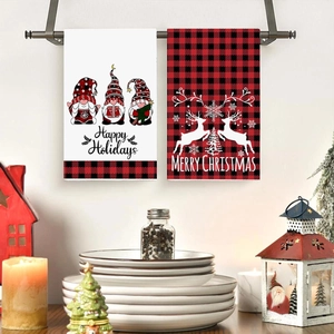 Set of 2 Christmas gnome and buffalo plaid kitchen hand towels on a metal rack
