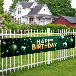 Soccer birthday banner featuring green balloons and football patterns on a white fence