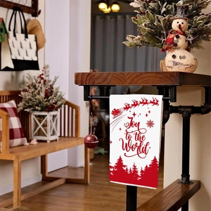Christmas hand towel featuring red reindeer and Joy to the World print on white fabric