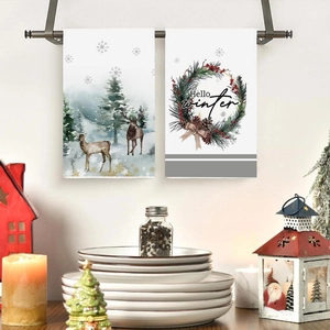 Two-pack Christmas hand towels featuring watercolor elk and festive pine cone wreath designs